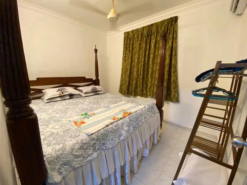 a bedroom with a bed with a ladder next to a window at AlFarizqi Muslim Residence SP in Sungai Petani