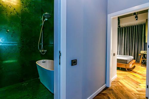 a bathroom with a bath tub in a room at Baku K NightsBridge Residance in Baku