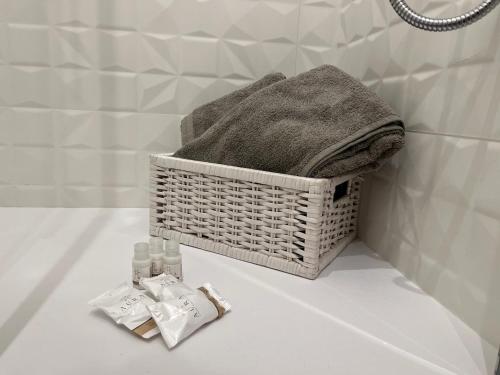 a bathroom with a basket with towels on a counter at Interno 4 - Luxury Holiday Rome in Rome