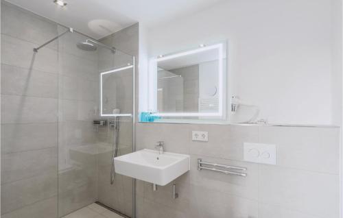 a white bathroom with a sink and a shower at Fewo 30 Putbus-rgen in Wreechen