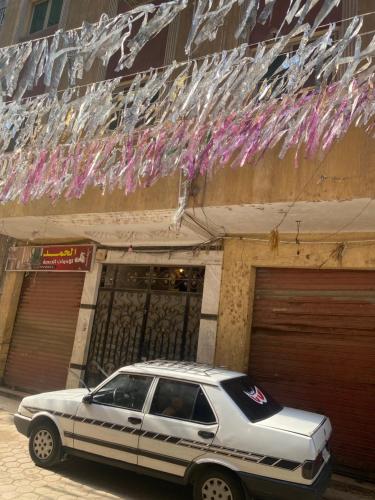 a white car parked in front of a building at Salam Appartment in Cairo