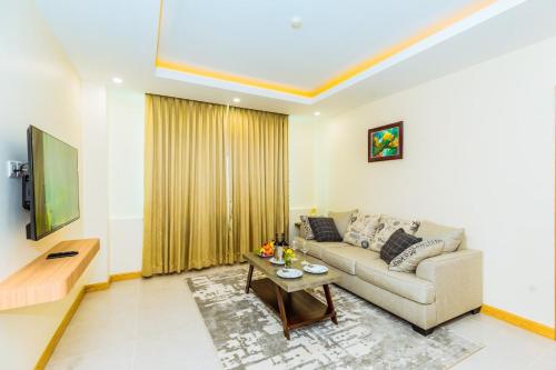 a living room with a couch and a table at Dynasty Casino Hotel in Bavet