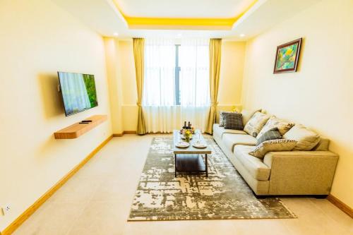 a living room with a couch and a table at Dynasty Casino Hotel in Bavet
