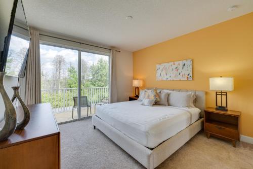 a bedroom with a large bed and a large window at Clermont Townhome with Pool about 9 Mi to Disney World! in Orlando