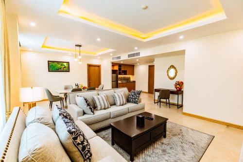 a living room with a couch and a table at Dynasty Casino Hotel in Bavet