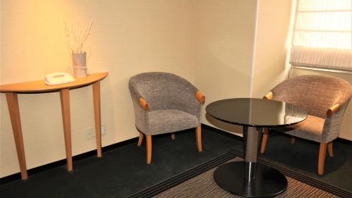 a meeting room with two chairs and a table at ANA Holiday Inn Sendai by IHG in Sendai