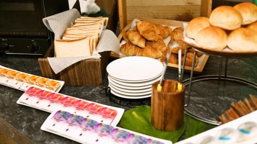 a table with a bunch of bread and pastries at ANA Holiday Inn Sendai by IHG in Sendai