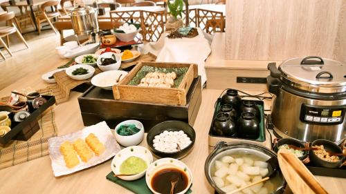a table topped with food and a pot on a stove at ANA Holiday Inn Sendai by IHG in Sendai
