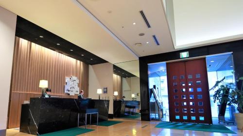 a lobby of a hotel with people sitting at a desk at ANA Holiday Inn Sendai by IHG in Sendai