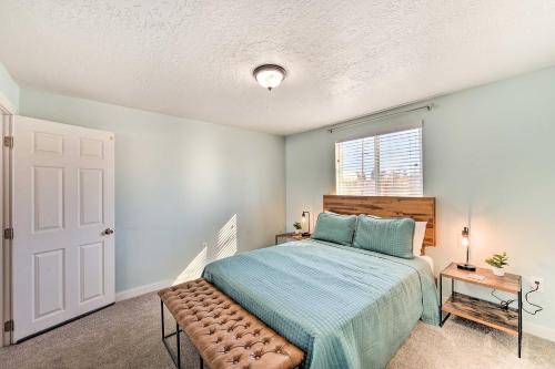 a bedroom with a bed with a bench in it at Centrally Located Pinedale Vacation Rental! in Pinedale