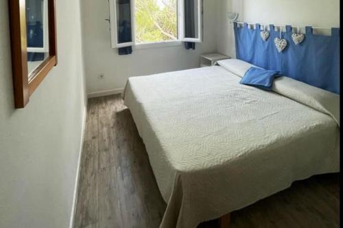 ein Schlafzimmer mit einem großen Bett mit einem blauen Vorhang in der Unterkunft Solisla in Arenal d'en Castell