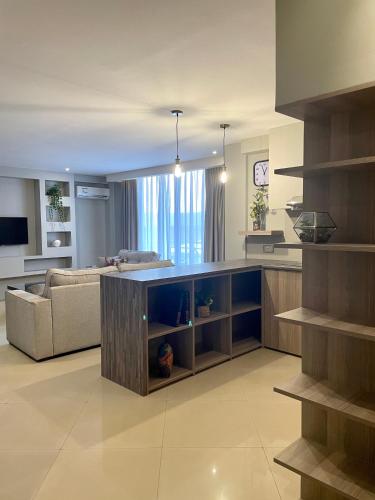 a living room with a couch and a kitchen at Meilin International Hotel in Kampala