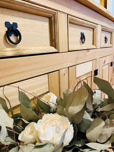 a vase of flowers sitting in front of a dresser at Hotel Marcincak*** in Mikulov