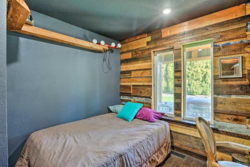 a bedroom with a bed in a room with wooden walls at Bellingham Vacation Rental with Private Deck in Bellingham
