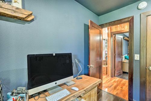 a computer monitor on a desk in a room at Bellingham Vacation Rental with Private Deck in Bellingham