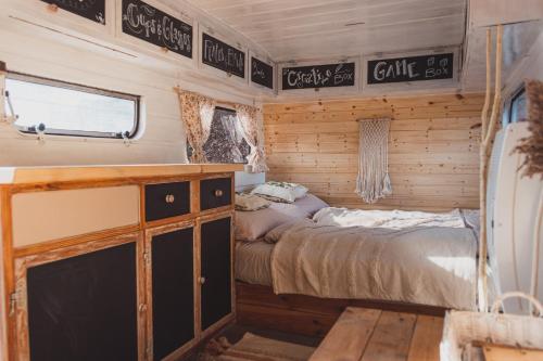 a bedroom in a rv with a bed in it at Caravan on Ranch in Třebívlice