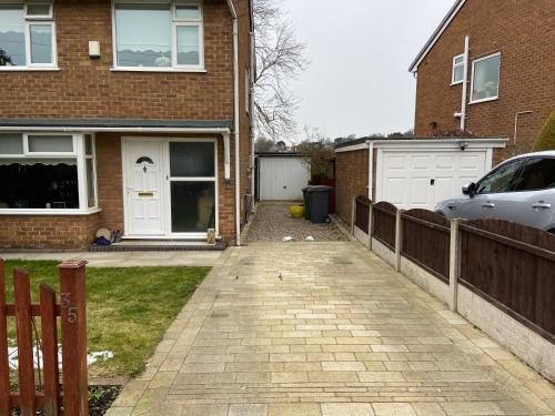 a driveway in front of a house with a fence at Cumberland Avenue prenton Wirral 3bed detached house with a lovely view looking out on to a field from the rear close to all amenities in Birkenhead