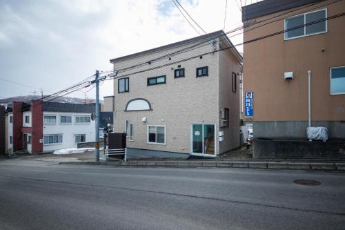 a building on the side of a street at Sumiyoshi House Room B in Otaru