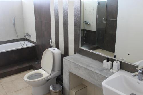 a bathroom with a toilet and a sink at Mount Marina Villas 12 in Galle