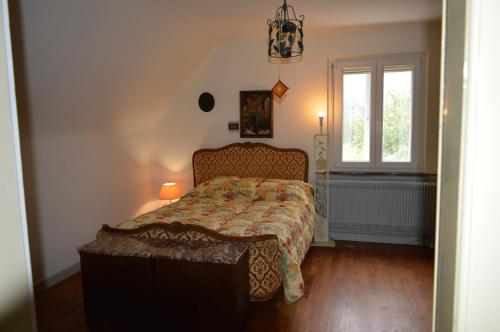 a bedroom with a bed with a comforter and a window at Chez Thérèse et Marguerite in Kindwiller