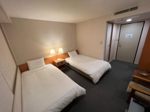 北見市にあるKitami Daiichi Hotel - Vacation STAY 73137vのホテルルーム ベッド2台&ランプ2つ付
