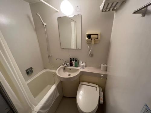 a small bathroom with a toilet and a sink at Kitami Daiichi Hotel - Vacation STAY 73148v in Kitami