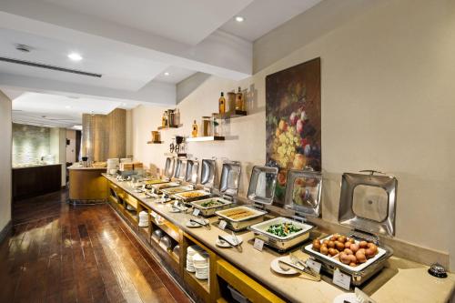 a buffet line of food in a restaurant at The LA Hotel 新世界伟瑞酒店 in Shenzhen