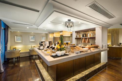 a kitchen with a long counter with food on it at The LA Hotel 新世界伟瑞酒店 in Shenzhen