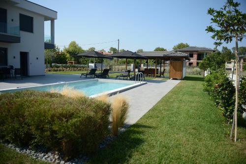 a swimming pool in a yard next to a house at Luxury Villa Plaka Litochorou with Pool in Plaka Litochorou
