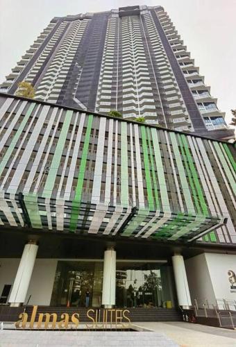 a tall building with a sign in front of it at Almas Suites Muji 100mbps Netflix By STAY in Nusajaya
