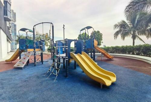 a playground with a slide and a slide at Almas Suites Muji 100mbps Netflix By STAY in Nusajaya