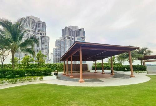 a pavilion in a park with tall buildings at Almas Suites Muji 100mbps Netflix By STAY in Nusajaya