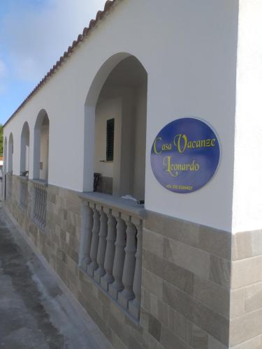 a building with a sign on the side of it at Casa vacanze Leonardo in Peschici