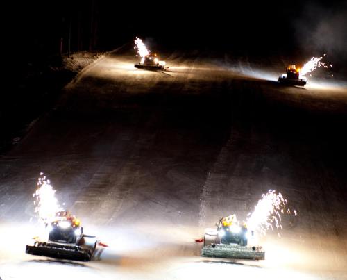 three tractors racing on a race track at night at Haus Ladner in See