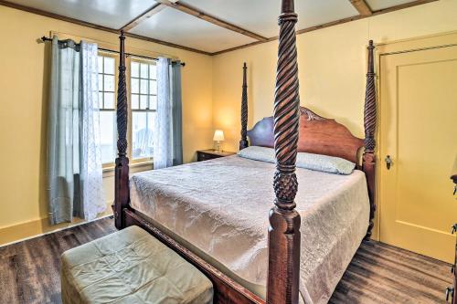 a bedroom with a four poster bed and windows at Forestport Home with Access to Otter Lake in Forestport