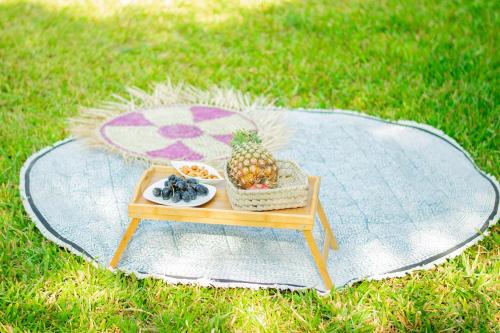 a table with a pineapple and a bowl of fruit on it at Lions' Luxury Eco Resort & Spa in Malindi