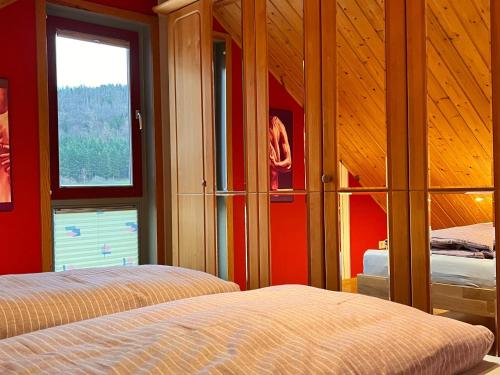 a bedroom with two beds and a window at Eifel-Ferienhaus Lavendel in Simmerath