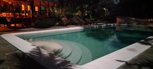 a swimming pool at a resort at night at Lions' Luxury Eco Resort & Spa in Malindi