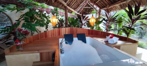 a dining table in a room with plants at Lions' Luxury Eco Resort & Spa in Malindi