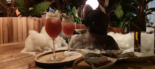 two champagne glasses sitting on a table with food at Lions' Luxury Eco Resort & Spa in Malindi