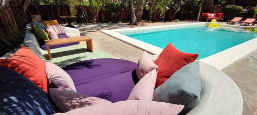 a person laying on a bed next to a swimming pool at Lions' Luxury Eco Resort & Spa in Malindi