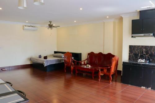 a living room with two chairs and a couch at Gvai Apartment in Phnom Penh