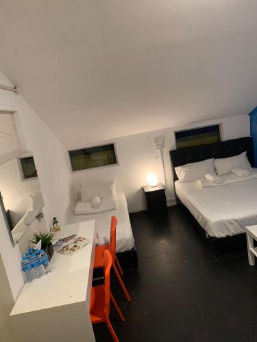 a small room with two beds and a table and chairs at Galaxy Pods @ Chinatown in Singapore