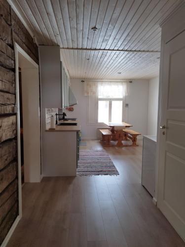 an empty room with a kitchen and a table at Granny´s House Kuusela in Portimo