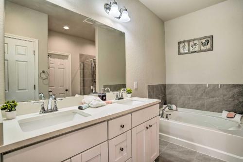 a bathroom with two sinks and a bath tub and a tub at San Antonio Vacation Rental with Hot Tub, Yard! in Selma