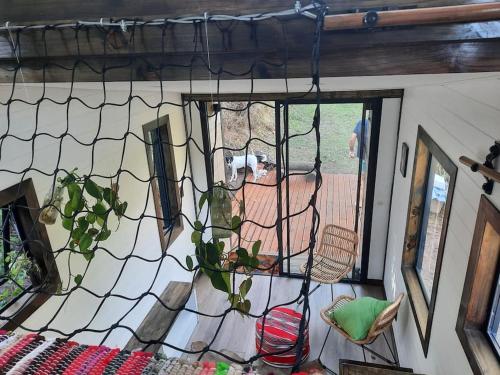 a net with a potted plant in a room at Tiny Home Trails End in Lovemore Park