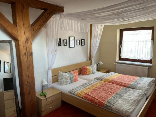 een slaapkamer met een groot bed en een raam bij Alte Druckerei in Quedlinburg