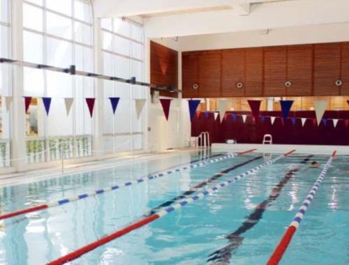a large swimming pool with a large window at Cosy two rooms apartment in Helsinki with free parking in Helsinki