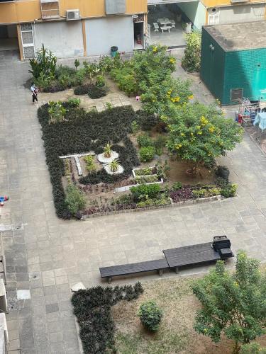 an overhead view of a garden with two benches at Impact Arena C3 Milo in Nonthaburi