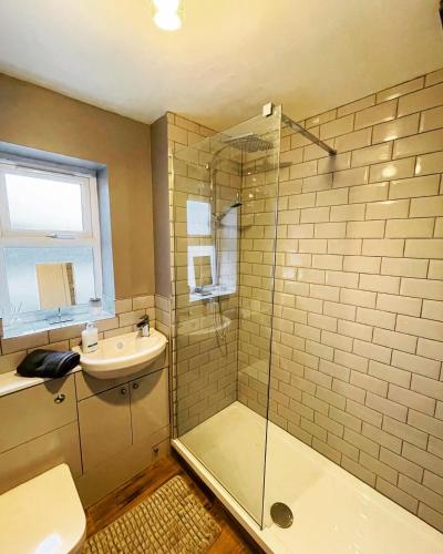 a bathroom with a glass shower and a sink at Two Double bedrooms apartment near Hull city centre in Hull